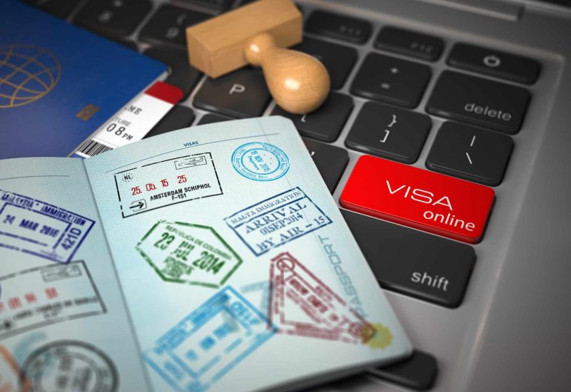 Visa online application concept. Open passport with visa stamps